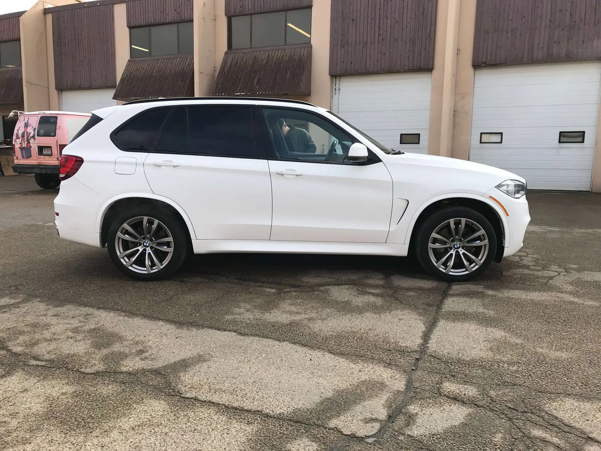 BMW X5 wrapped in Matte White, passenger side view